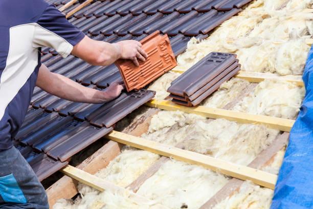 a roofer laying tile on the roof